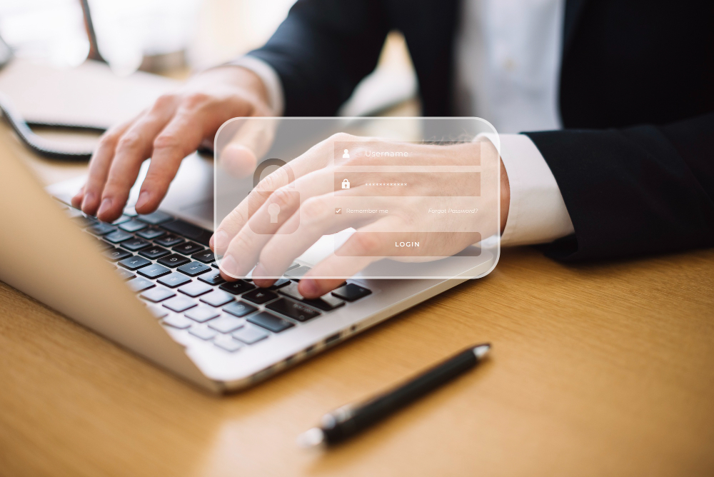 Pessoa digitando seu login e senha no computador, simulando como cuidamos dos dados pessoais